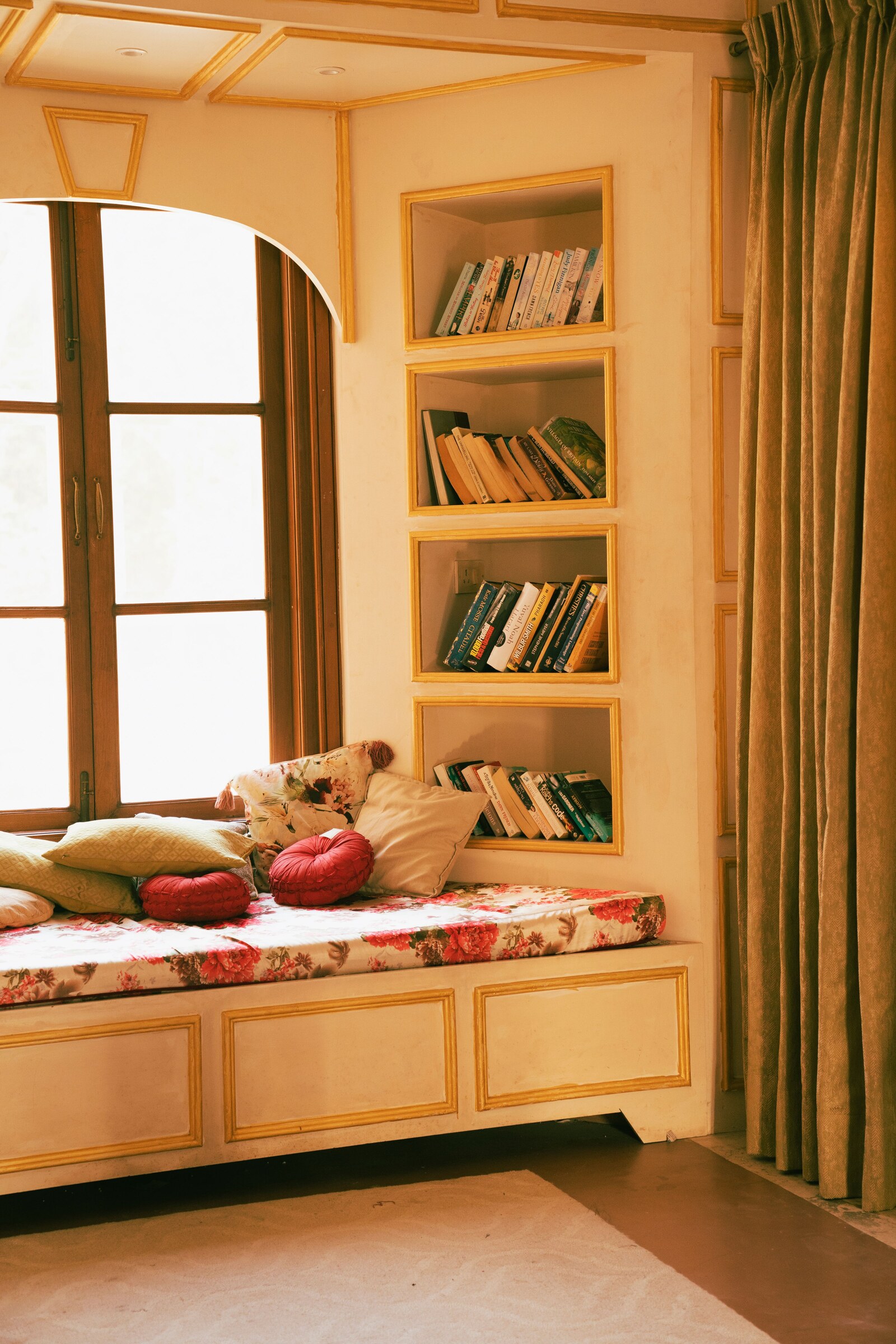 High-resolution real photograph of a fitted window seat with integrated bookcases